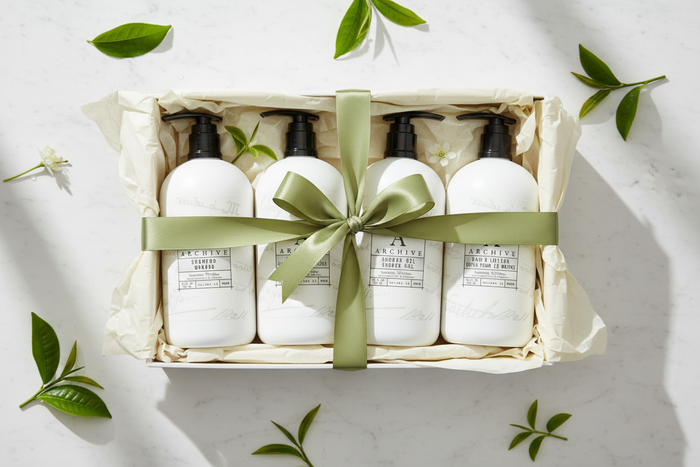 Archive Green Tea & Willow luxury hotel bath set in a gift box with ribbon and natural foliage.