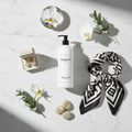 Balmain Paris Body Lotion - luxury hotel body lotion on marble flat lay with Parisian styling