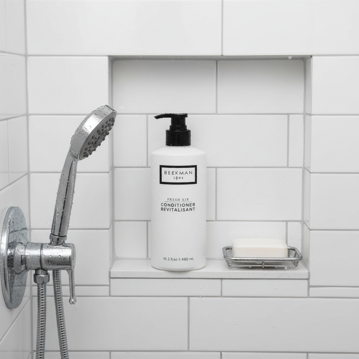 Beekman 1802 Fresh Air Conditioner overhead shot white bottle in modern shower niche white tiles - premium goat milk conditioner
