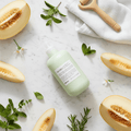 Davines MOMO Conditioner flat lay with fresh melon and Italian spa elements