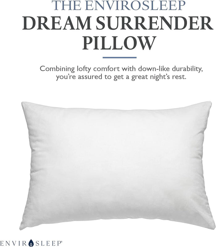The Envirosleep Dream Surrender Pillow, white and plump, designed for hotel use with a tagline stating 'Combining lofty comfort with down-like durability, you're assured to get a great night's rest.'.