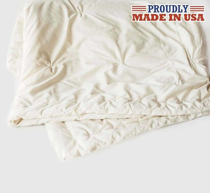 Turmerry lightweight natural wool comforter laid out, on white background, with proudly made in usa logo atop.