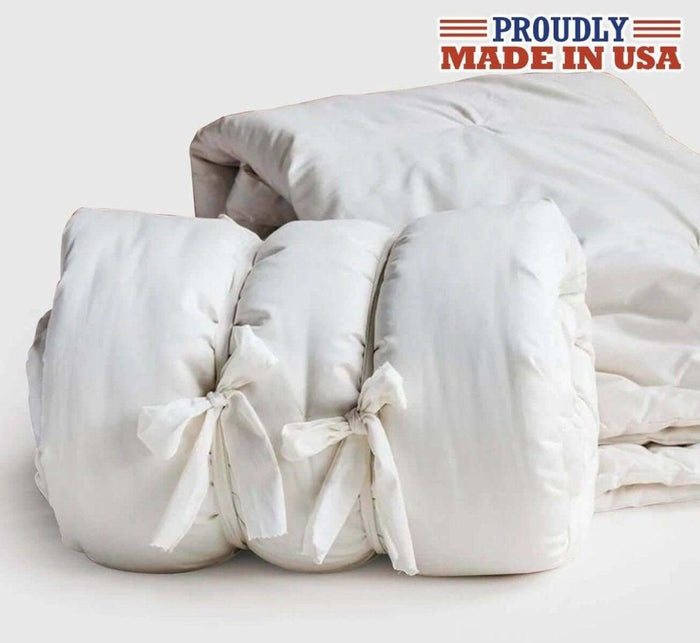 Turmerry made in USA lightweight natural wool comforter rolled up with tie closures.