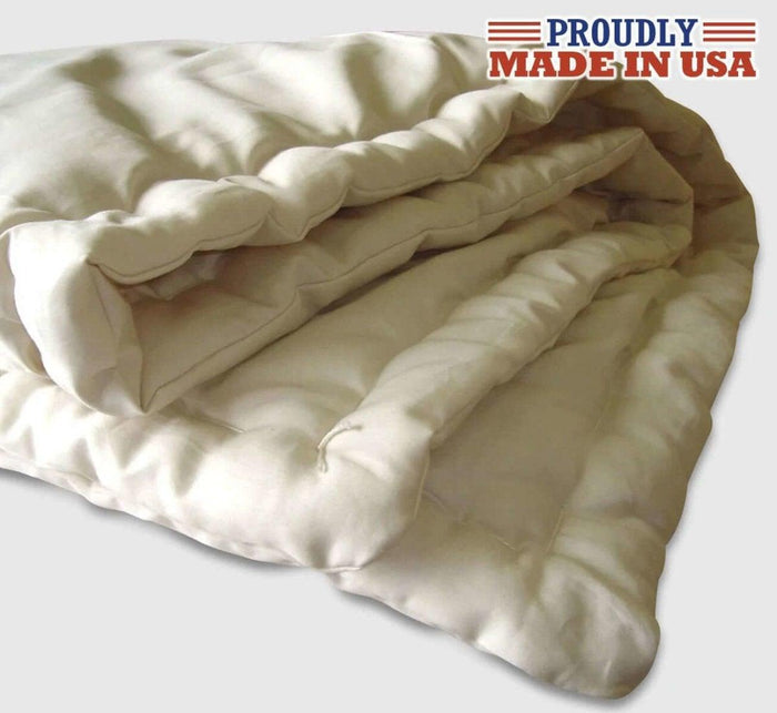 Turmerry made in USA lightweight natural wool comforter with quilted design, on gray background.