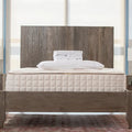 Bedroom view Naturepedic Organic Cotton Percale Sheets + Pillowcases stacked on mattress