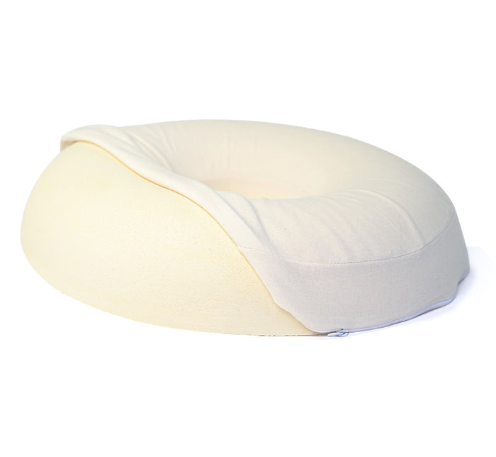 Turmerry latex donut pillow with donut shaped design and white cover half open, on white background.