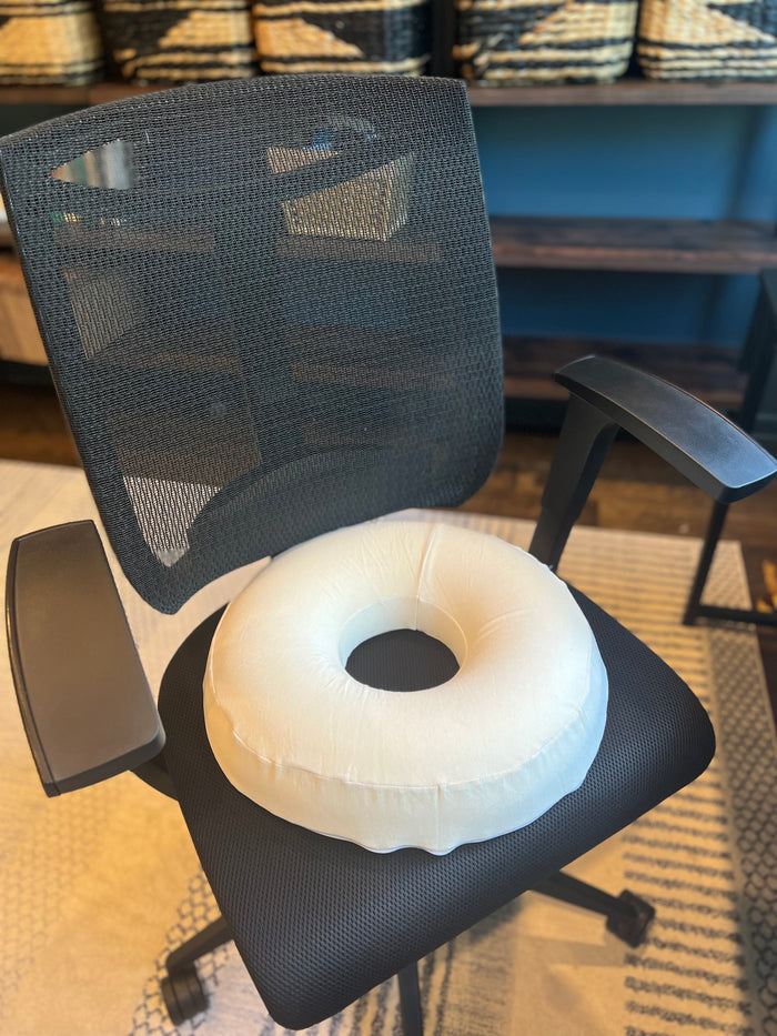 Turmerry latex donut pillow displayed on office chair for providing tailbone relief support.
