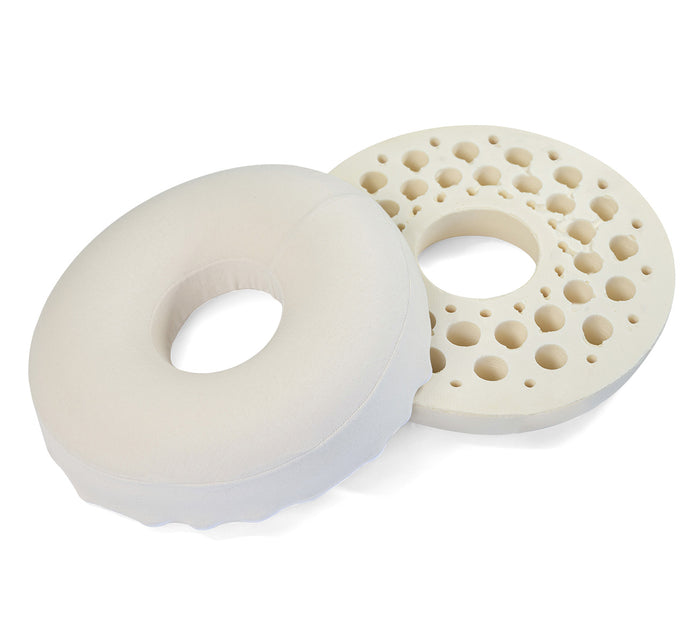Two Turmerry latex donut pillows, one placed upside down to show perforated design, on white background.