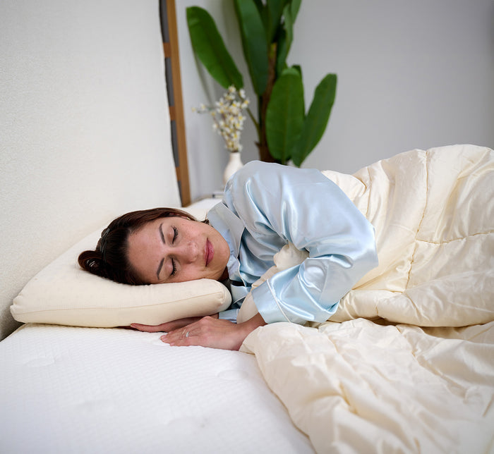 Side view of woman sleeping on her side on Turmerry Organic Latex Pillow.