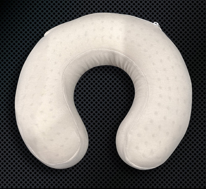 Turmerry latex travel neck pillow with white cover on dark textured background displaying U-shape.