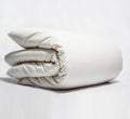 Turmerry Organic Percale Duvet Cover put on a folded duvet, on a light gray background.