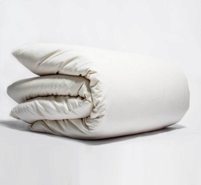 Turmerry Organic Percale Duvet Cover put on a folded duvet, on a light gray background.
