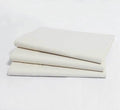 Turmerry organic sateen natural color sheet set folded and stacked.