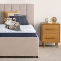 Sheep laying upside down on an 6 inch foam mattress sitting in a beige bedframe || feel: Foam (6" Profile)