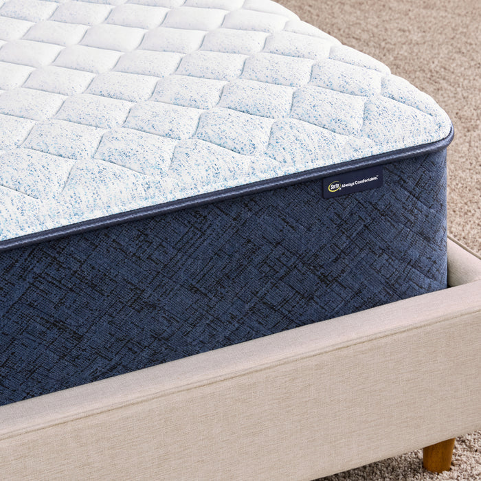 Corner of 11 inch foam mattress sitting in a beige bedframe || feel: Firm