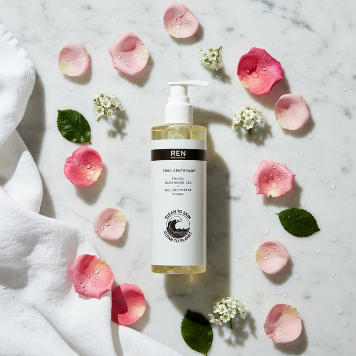 REN Rosa Centifolia Facial Cleansing Gel flat lay with rose petals on white marble