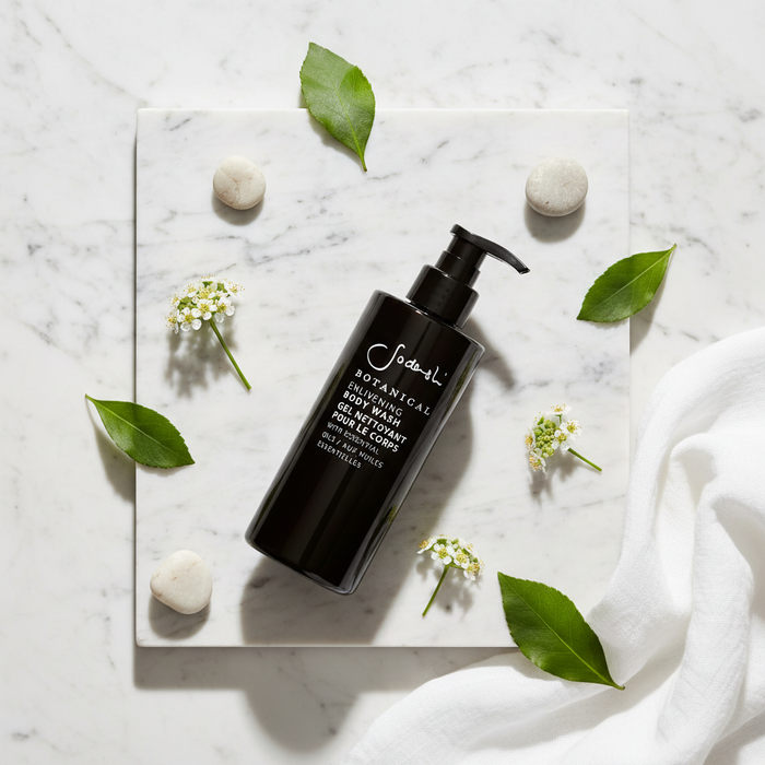Sodashi Botanical Body Lotion flat lay with botanicals on white marble