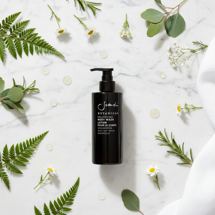 Sodashi Botanical Body Wash flat lay with botanicals on white marble