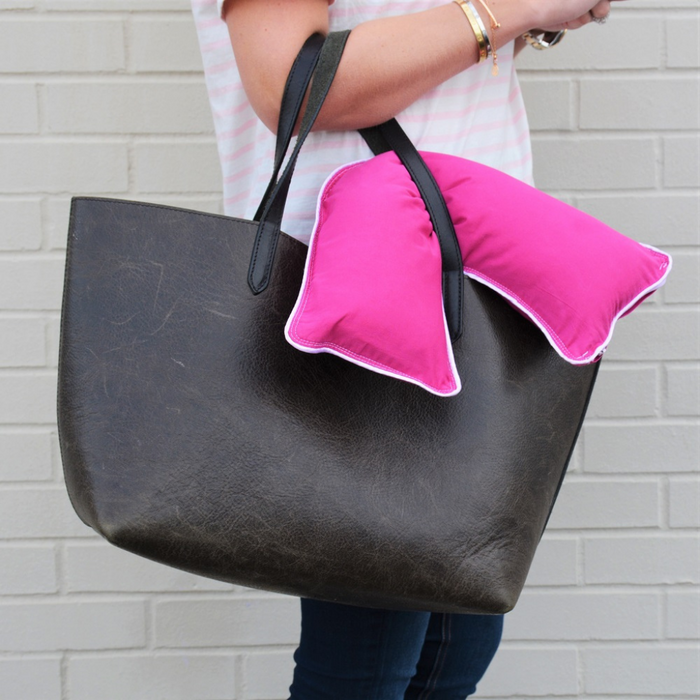 woman holding The Pillow Bar Jetsetter Mini Down Pillow