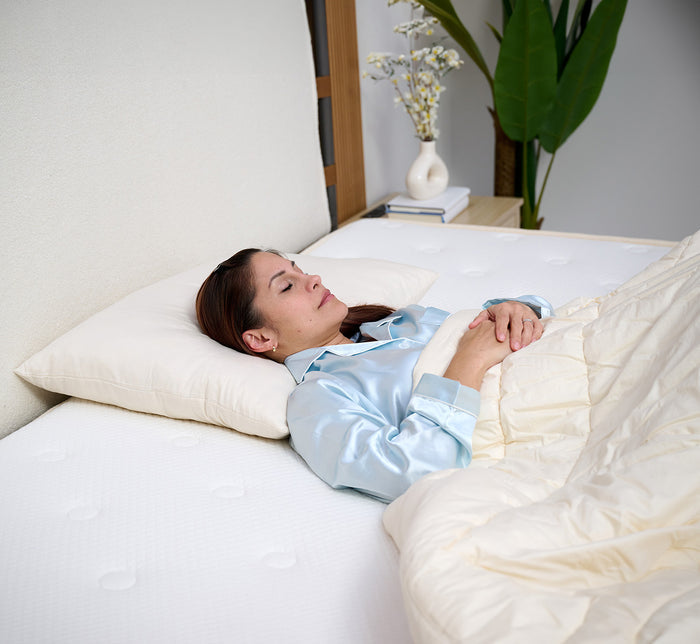 Woman sleeping on her back on Turmerry Wool Pillow.